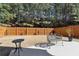 Fenced backyard with a patio and a well-maintained lawn, creating an inviting outdoor space at 6160 Shiloh Woods Dr, Cumming, GA 30040