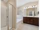 Bathroom features double sink vanity, soaking tub, glass enclosed shower and stylish finishes at 6160 Shiloh Woods Dr, Cumming, GA 30040