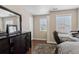 Bedroom with dark wood dresser, chair and desk, and a view of natural light at 6160 Shiloh Woods Dr, Cumming, GA 30040