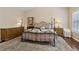 Bedroom with a large bed, neutral carpet, and natural light from the windows at 6160 Shiloh Woods Dr, Cumming, GA 30040