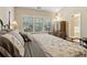 Bedroom with a large bed, hardwood floors, and bright natural light from the windows at 6160 Shiloh Woods Dr, Cumming, GA 30040