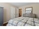 Comfortable bedroom with a dresser, queen bed, and view into hallway at 6160 Shiloh Woods Dr, Cumming, GA 30040