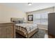 Neutral bedroom features wood furnishings, natural light, and a comfortable queen-sized bed at 6160 Shiloh Woods Dr, Cumming, GA 30040