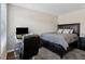 Neutral-toned bedroom with black desk and chair, queen bed, and plush carpet at 6160 Shiloh Woods Dr, Cumming, GA 30040