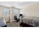 Comfortable bedroom with two windows, a sleek black desk, and a queen-sized bed at 6160 Shiloh Woods Dr, Cumming, GA 30040