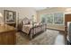 Bedroom showcasing a large bed, plush carpet, and natural light from the window at 6160 Shiloh Woods Dr, Cumming, GA 30040
