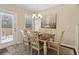 Cozy dining area featuring a chandelier, wood table and chairs, and a sliding glass door to the exterior at 6160 Shiloh Woods Dr, Cumming, GA 30040