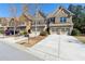 Lovely townhome with a two-car garage, long concrete driveway, and mature landscaping at 6160 Shiloh Woods Dr, Cumming, GA 30040