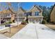 Beautiful brick townhome with a two-car garage and well-maintained landscaping and a long driveway at 6160 Shiloh Woods Dr, Cumming, GA 30040