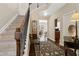 Foyer showcasing hardwood floors, staircase, decor, and seamless transition to living spaces at 6160 Shiloh Woods Dr, Cumming, GA 30040