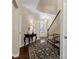 Bright foyer featuring hardwood floors, staircase, stylish decor, and open layout at 6160 Shiloh Woods Dr, Cumming, GA 30040