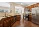 Modern kitchen with stainless steel appliances, granite countertops, and dark wood cabinetry at 6160 Shiloh Woods Dr, Cumming, GA 30040