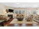 Bright and airy living room with a fireplace, hardwood floors, and abundant natural light at 6160 Shiloh Woods Dr, Cumming, GA 30040