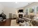 Well-lit living room with a fireplace, flat screen television, and comfortable seating arrangements at 6160 Shiloh Woods Dr, Cumming, GA 30040