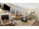 Bright living room featuring a cozy fireplace, large windows, and comfortable seating arrangement at 6160 Shiloh Woods Dr, Cumming, GA 30040