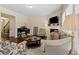 Bright living room with hardwood floors, a fireplace, and an open view of the staircase to the second level at 6160 Shiloh Woods Dr, Cumming, GA 30040