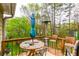 Relaxing outdoor deck furnished with chairs, table, umbrella, and scenic green backyard views at 990 Fox Valley Trl, Stone Mountain, GA 30088