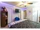 Modern bedroom design featuring a comfortable bed, tv, ceiling fan, and accent lighting at 990 Fox Valley Trl, Stone Mountain, GA 30088