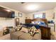 Bedroom with decorative pillows and blanket on the bed and seating couch near shelving and tv at 990 Fox Valley Trl, Stone Mountain, GA 30088