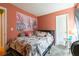 Cozy bedroom with a full-sized bed, Paris-themed decorations, and a peach colored wall at 990 Fox Valley Trl, Stone Mountain, GA 30088