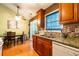 Kitchen leading into dining room with granite countertops, stainless steel appliances, and wood cabinets at 990 Fox Valley Trl, Stone Mountain, GA 30088