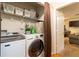 Laundry room with shelving, washer and dryer and a dark curtain at 990 Fox Valley Trl, Stone Mountain, GA 30088