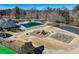 Community amenities featuring a pool, playground, swings, and clubhouse with lush landscaping at 1110 Croftmoore Lndg, Suwanee, GA 30024