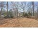 A sprawling backyard with mature trees offers plenty of space for outdoor activities at 1110 Croftmoore Lndg, Suwanee, GA 30024