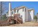 Rear exterior of home showcasing a large backyard, back deck, and privacy fence at 1110 Croftmoore Lndg, Suwanee, GA 30024