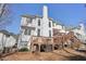 Exterior of home with a multi-tiered wooden deck and landscaped backyard at 1110 Croftmoore Lndg, Suwanee, GA 30024