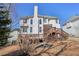 Rear exterior view of home with multi-level wooden deck and landscaped yard at 1110 Croftmoore Lndg, Suwanee, GA 30024