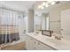 Well-lit bathroom featuring a double vanity, a shower-tub combination, and neutral color palette at 1110 Croftmoore Lndg, Suwanee, GA 30024