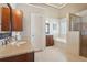 Bright bathroom with granite countertops, dual vanities, and a separate shower and tub at 1110 Croftmoore Lndg, Suwanee, GA 30024