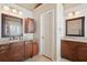 Bathroom with dual vanities, granite countertops, and modern lighting fixtures at 1110 Croftmoore Lndg, Suwanee, GA 30024