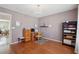 Bright bedroom featuring hardwood floors, chandelier, and furnishings, perfect for a home office or guest room at 1110 Croftmoore Lndg, Suwanee, GA 30024