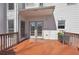 A cozy wooden deck with a covered area and double doors leading inside offers a relaxing outdoor space at 1110 Croftmoore Lndg, Suwanee, GA 30024