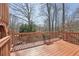 A wooden deck with railing offers scenic views of the surrounding landscape at 1110 Croftmoore Lndg, Suwanee, GA 30024