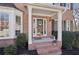 Inviting front entrance with brick steps, white columns, and a decorative front door at 1110 Croftmoore Lndg, Suwanee, GA 30024