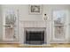 Elegant fireplace with white mantel, decorative screen, and natural light from two windows at 1110 Croftmoore Lndg, Suwanee, GA 30024