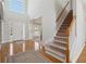Bright foyer with hardwood floors, staircase, and an open view to the dining and living area at 1110 Croftmoore Lndg, Suwanee, GA 30024