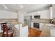 Well-lit kitchen with stainless steel appliances and granite counter tops at 1110 Croftmoore Lndg, Suwanee, GA 30024