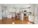 Spacious kitchen with a breakfast bar and bright white cabinetry at 1110 Croftmoore Lndg, Suwanee, GA 30024
