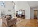 Bright living room with a fireplace, hardwood floors, and large windows with great natural light at 1110 Croftmoore Lndg, Suwanee, GA 30024
