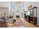 Bright living room featuring a fireplace, tall windows, and hardwood floors at 1110 Croftmoore Lndg, Suwanee, GA 30024
