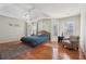 Spacious main bedroom with hardwood floors, tray ceiling, ceiling fan, and lots of natural light from multiple windows at 1110 Croftmoore Lndg, Suwanee, GA 30024