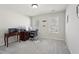 A well-lit home office featuring carpeted floors, dual windows, and a desk setup for productivity at 1110 Croftmoore Lndg, Suwanee, GA 30024