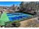 Aerial view of well-maintained tennis courts at The Lansmoore Club, perfect for recreational play at 1110 Croftmoore Lndg, Suwanee, GA 30024