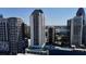 An aerial view showcasing a luxurious high-rise surrounded by lush greenery and neighborhood amenities at 1280 W Peachtree Nw St # 1712, Atlanta, GA 30309