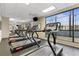 Gym featuring a row of treadmills, rubber flooring, and floor-to-ceiling windows with sky views at 1280 W Peachtree Nw St # 1712, Atlanta, GA 30309