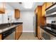 Updated kitchen features wood cabinets, sleek black countertops, and stainless steel appliances at 1280 W Peachtree Nw St # 1712, Atlanta, GA 30309